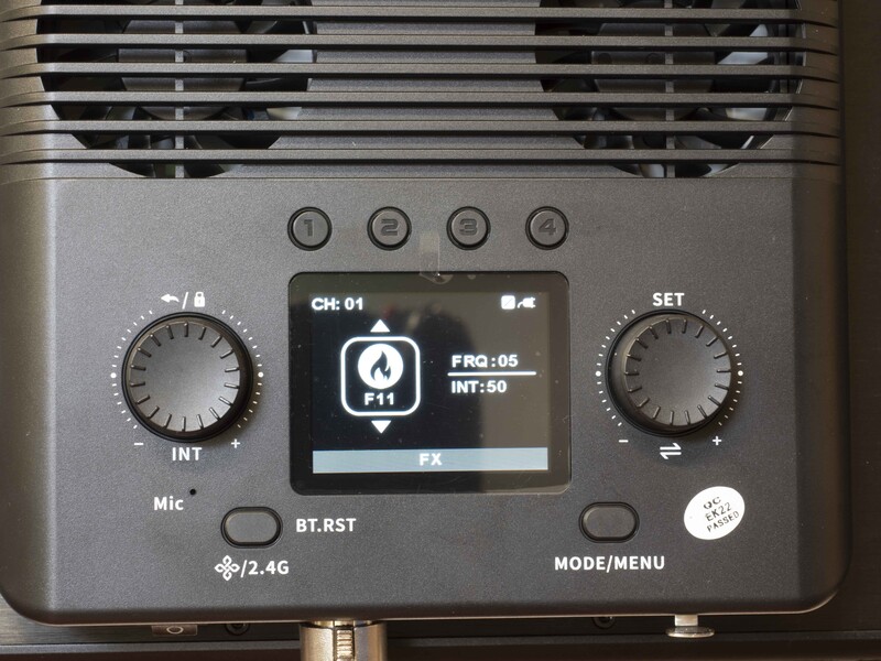 Close-up of a portable audio recorder's control panel with dual knobs, small display screen, and mode buttons.