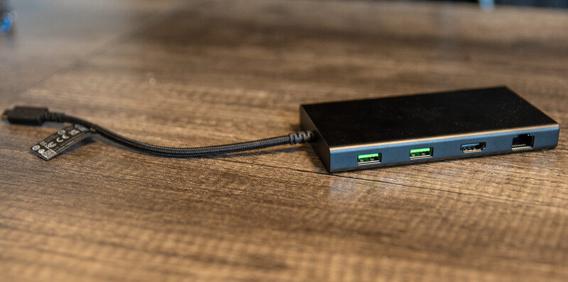 Razer USB C Dock on desk with USB and Network ports