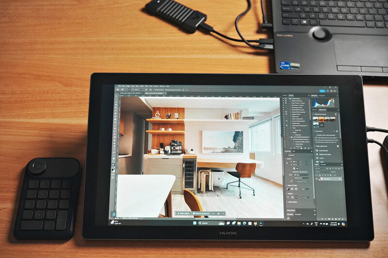 3D architectural rendering of a modern interior space displayed on a tablet with Photoshop open.