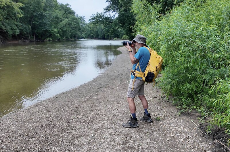 Demonstrating handholding technique along a river