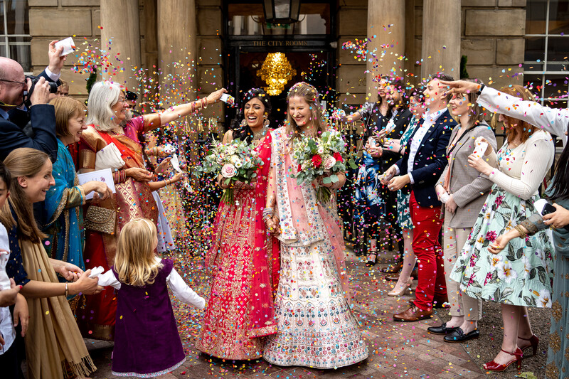 Wedding couple being cheered by family