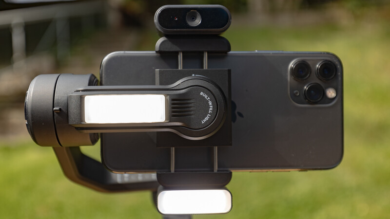 Smartphone mounted on a gimbal with fill lights attached to the rig.