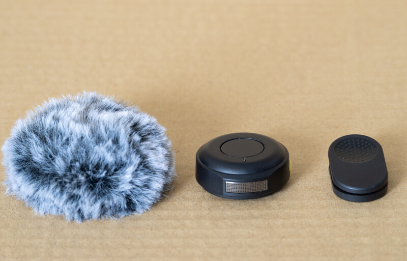 Three microphone windscreen and accessory components arranged in decreasing size order.