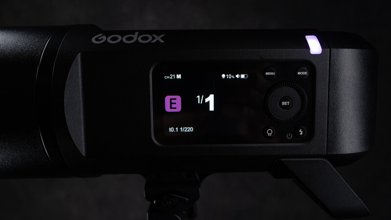 Godox camera flash with LCD screen displaying settings: f/1, ISO 21M, and date 10.1.1/220.