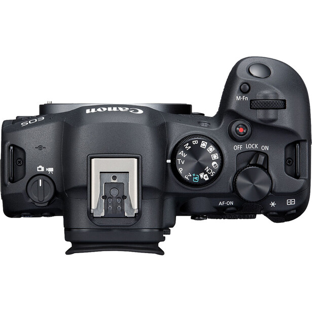 Top-down view of a professional DSLR camera body showing the hot shoe, mode dial, and control buttons.