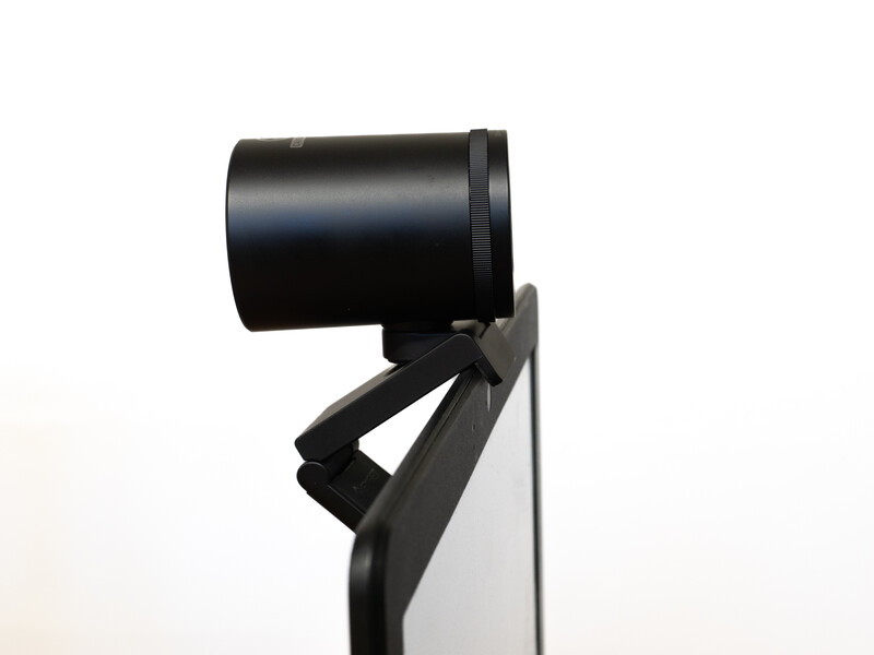 Black spotlight fixture mounted on a stand against a white background.