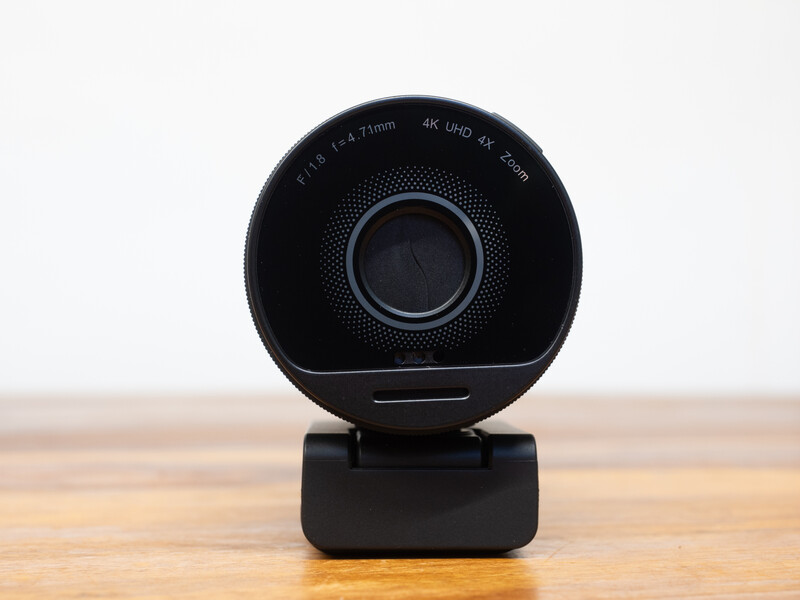 Black spherical camera with 4K UHD capability mounted on a small rectangular base, displayed on a wooden surface.