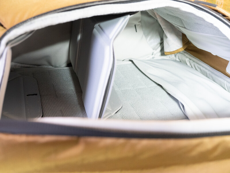 Yellow car interior viewed through open window showing white bedding or fabric on seat.