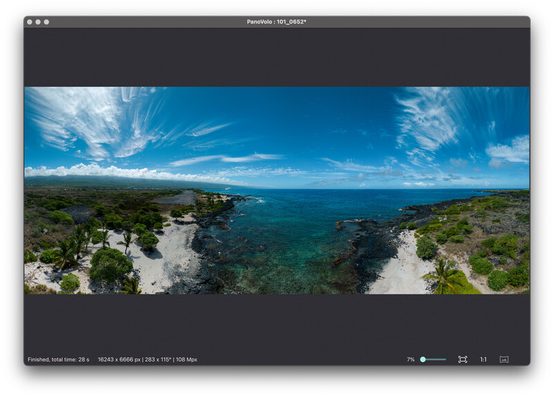 Panoramic coastal landscape with turquoise waters, rocky white cliffs, and green vegetation under blue sky.