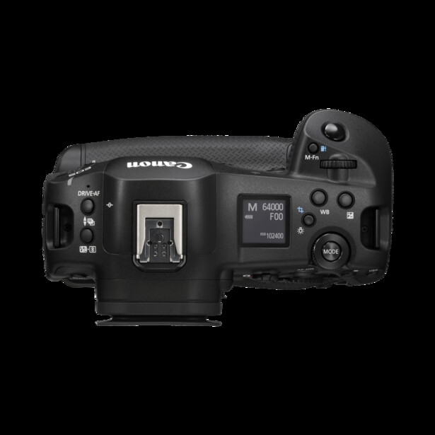 Top-down view of a black mirrorless camera body showing the hot shoe, LCD screen, and control dials.