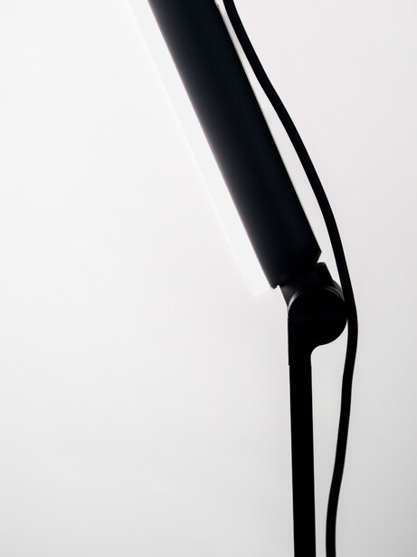 High-contrast silhouette of a bent arm and hand against a white background.