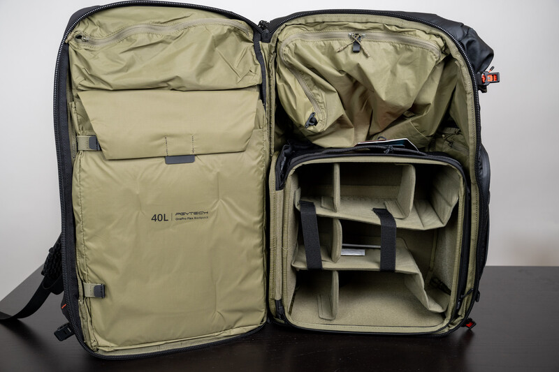 Open 40L camera backpack with tan interior showing padded dividers and organizational compartments.
