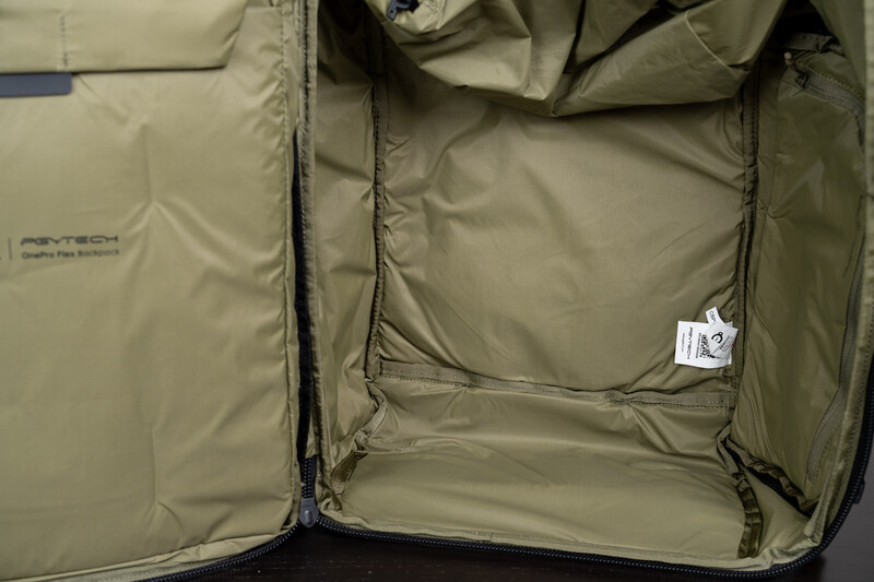 Interior of an open tan luggage case with fabric lining and zippered compartments.