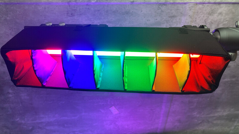 Colorful LED light display with seven illuminated sections transitioning through red, magenta, blue, cyan, green, yellow, and red again.