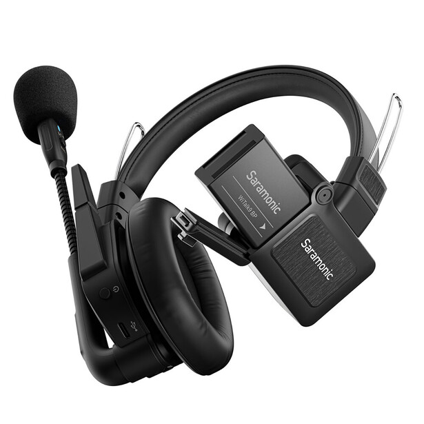 Wireless headphones and transmitter units arranged on white background.