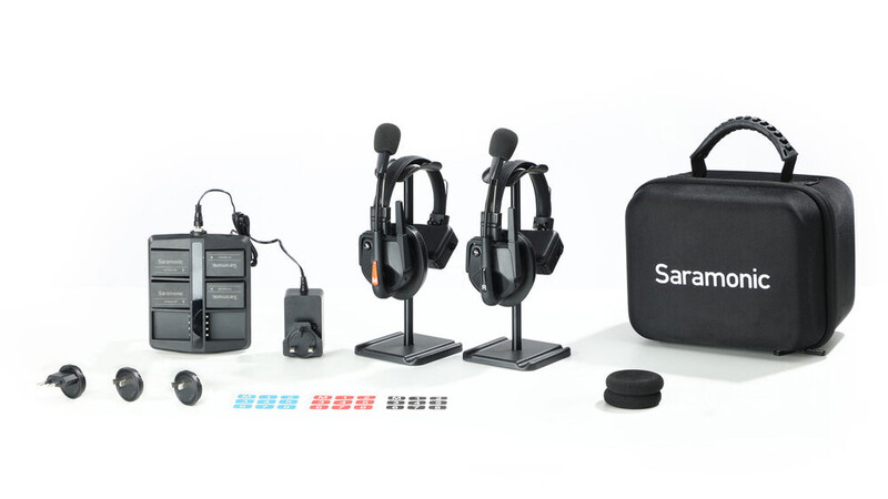 Wireless microphone system kit with dual headset mics, charging case, and accessories.