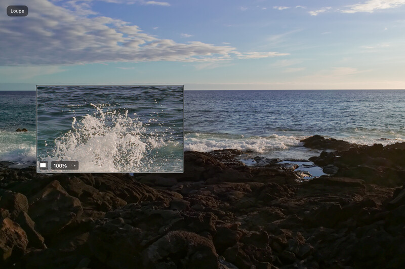 Coastal seascape with rocky shoreline in foreground and wave detail inset showing white water spray.