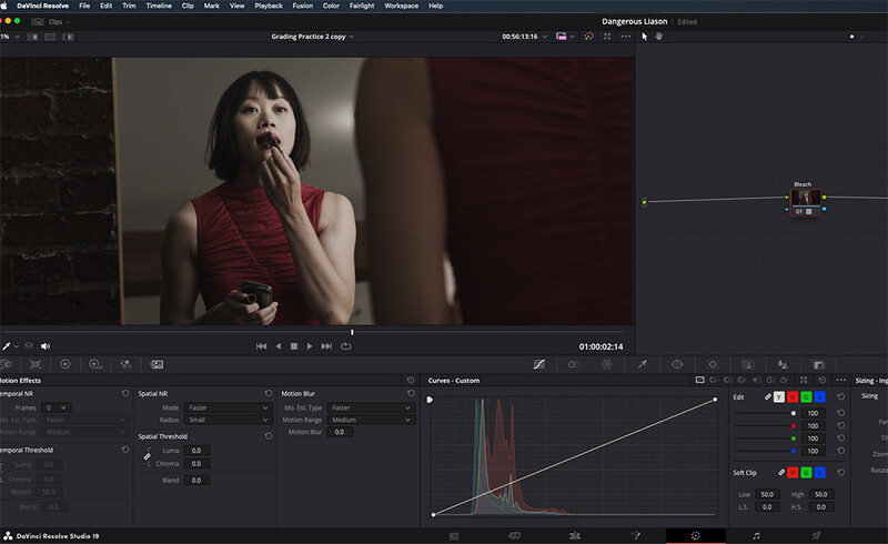 Screenshot of video editing software showing color grading interface with histogram and a woman in red clothing.