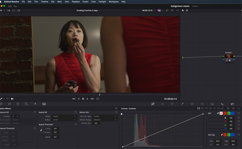 Screenshot of video editing software showing a woman in a red sleeveless top with histogram and color grading panels visible.