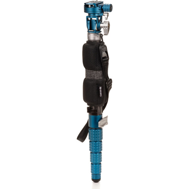 Blue and black monopod with ball head mounted on top and grip strap attached to shaft.