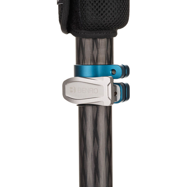 Seatpost collar clamps mounted on a carbon fiber bicycle seatpost, showing blue and silver anodized aluminum components.