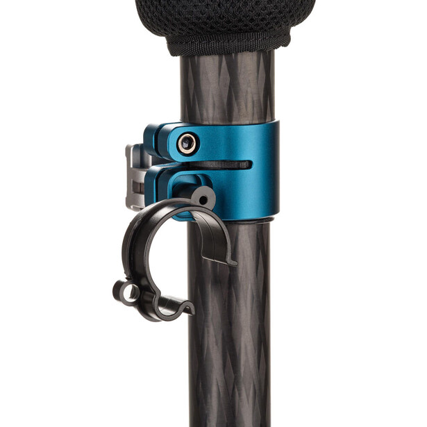 Blue microphone shock mount with adjustment knob securing a microphone to a cylindrical pole.