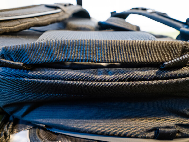 Folded blue and gray striped fabric with natural lighting creating shadows and texture detail.