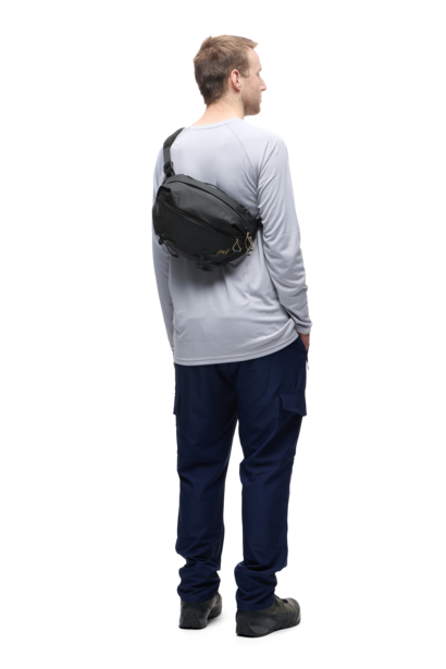Man wearing a black crossbody bag over one shoulder, viewed from behind.