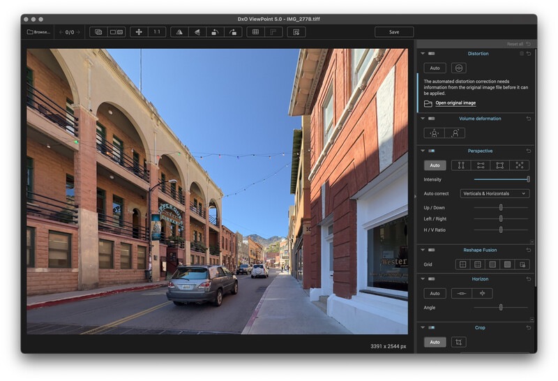 Screenshot of photo editing software displaying an urban street scene with historic brick buildings.
