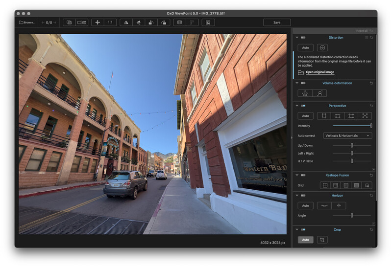 Screenshot of photo editing software displaying a street scene with historic brick buildings and parked cars.