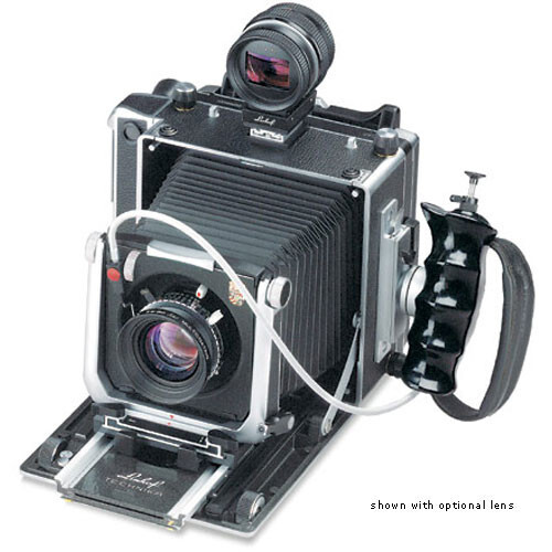 Large format film camera with bellows, mounted lens, and light meter on top, displayed with optional accessories.