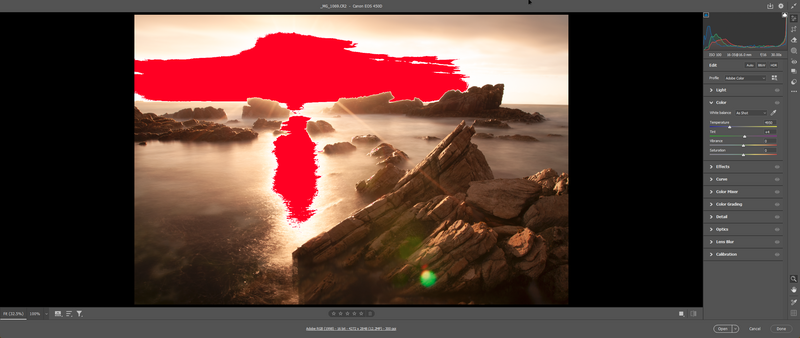 Screenshot of photo editing software showing a coastal landscape with red selection mask overlay.