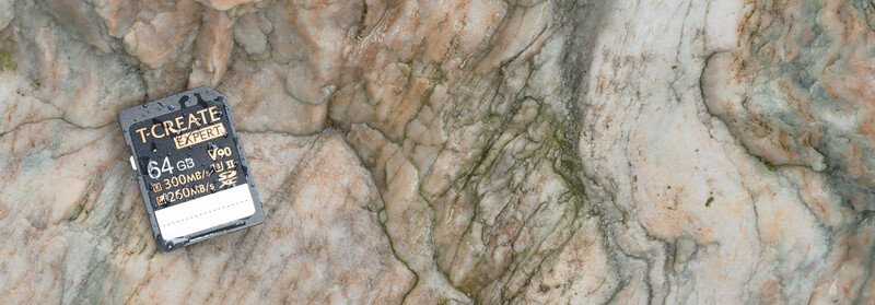 T-Create Expert 64GB SD card on textured stone surface.