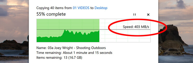 Screenshot of a file transfer dialog showing 403 MB/s copy speed while transferring video files to desktop.