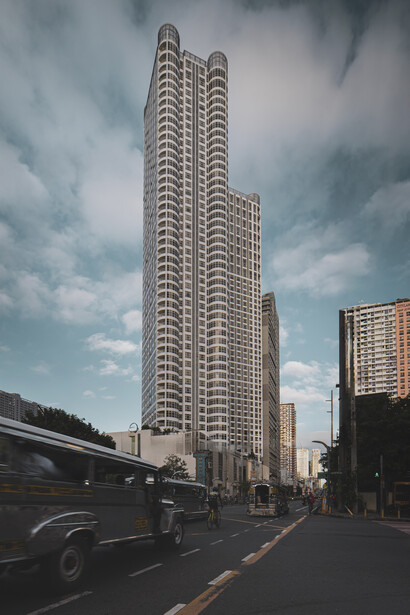 Tall residential skyscraper with repetitive window pattern against dramatic cloudy sky on urban street.