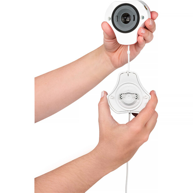 Illustration of hands holding a compact white and gray security camera with cable attachment shown separately below.