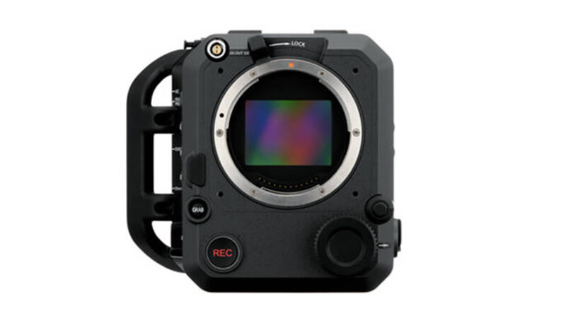 Professional cinema camera body with integrated handle, sensor visible through lens mount opening.