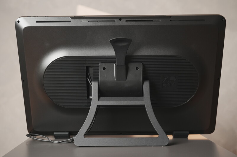 Rear view of a tablet or display device in a gray stand against a neutral background.