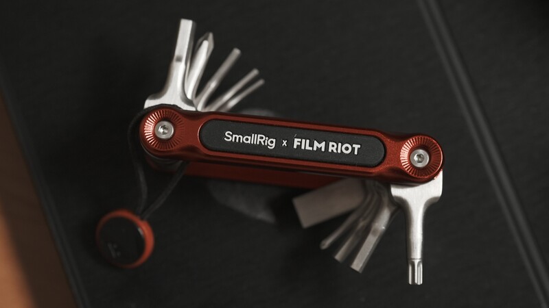 SmallRig × Film Riot multi-tool with red handles and extended hex keys and screwdriver bits.