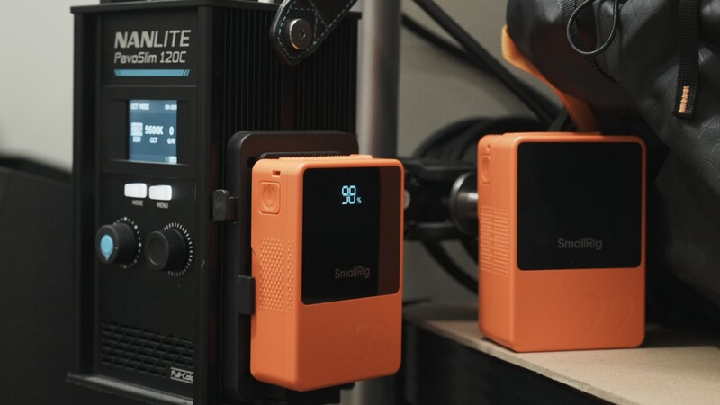 Nanlite PavoSim 120C light and two orange SmallRig monitor cases arranged on a surface.