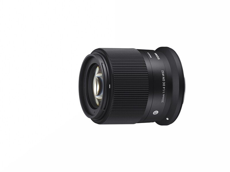 Black prime lens with ribbed focus ring and prominent front element viewed at three-quarter angle.