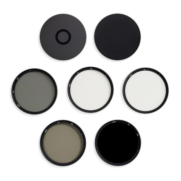 Illustration of seven camera lens filters arranged in three rows showing different optical densities and coatings.
