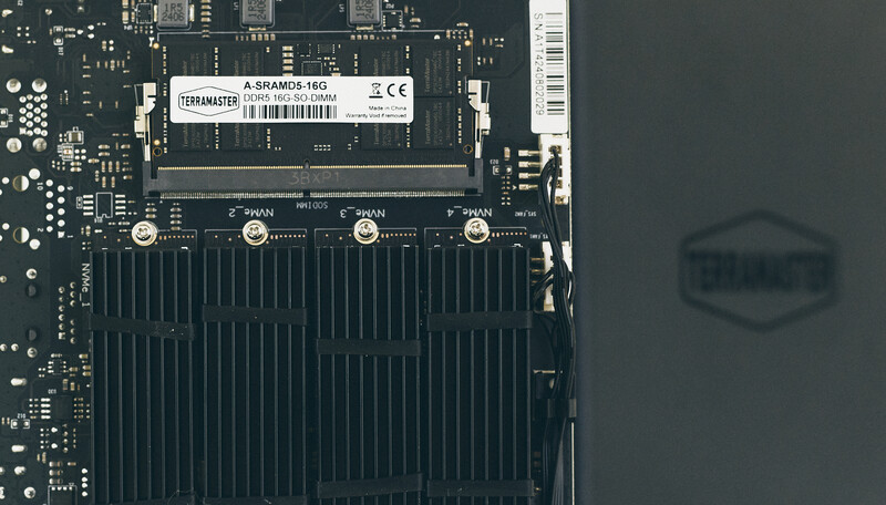 Close-up of a computer motherboard with an M.2 SSD and RAM module installed.