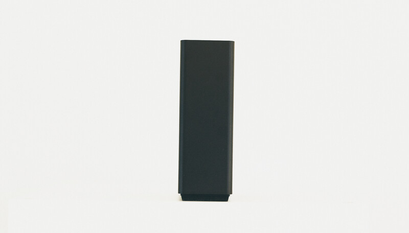 Tall dark rectangular box positioned against a neutral background.