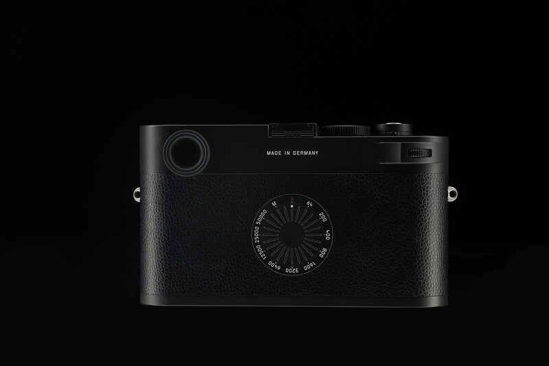 Top-down view of a black rangefinder camera with manual focus dial and viewfinder, marked 'Made in Germany.'
