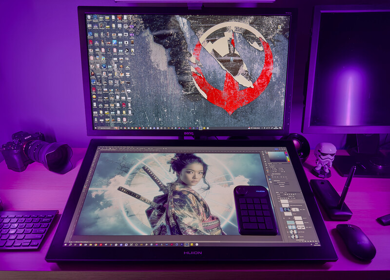 Creative workspace with dual monitors displaying photo editing software and a portrait image under purple ambient lighting.