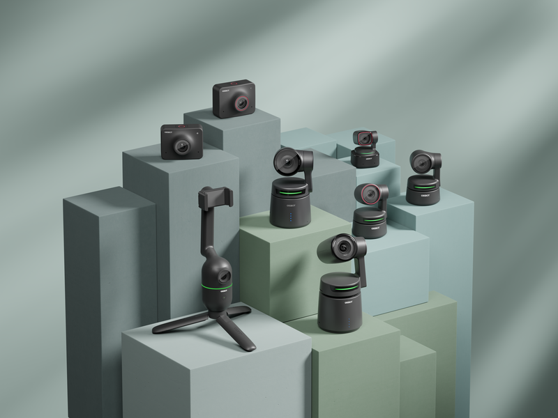 Array of compact camera equipment and lenses arranged on geometric concrete display blocks with dramatic diagonal lighting.