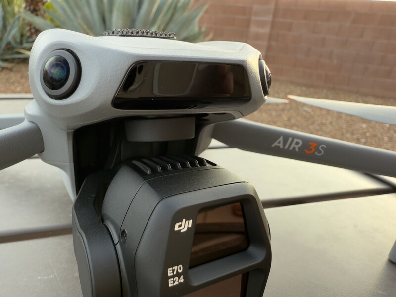 DJI Air 3S drone with mounted camera gimbal and lens visible from above.
