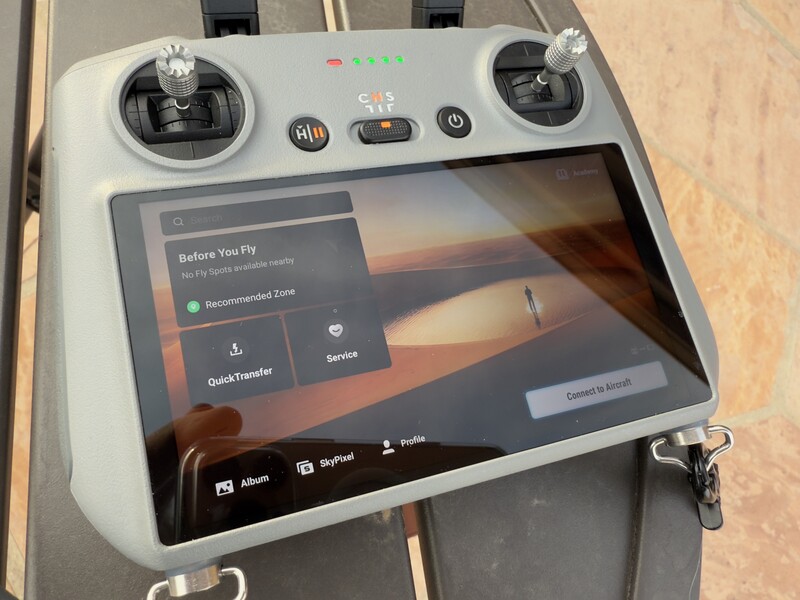 DJI drone remote controller with integrated tablet display showing flight preparation interface.