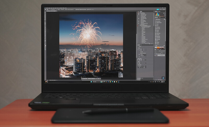 Screenshot of photo editing software displaying a cityscape with fireworks during twilight hour.